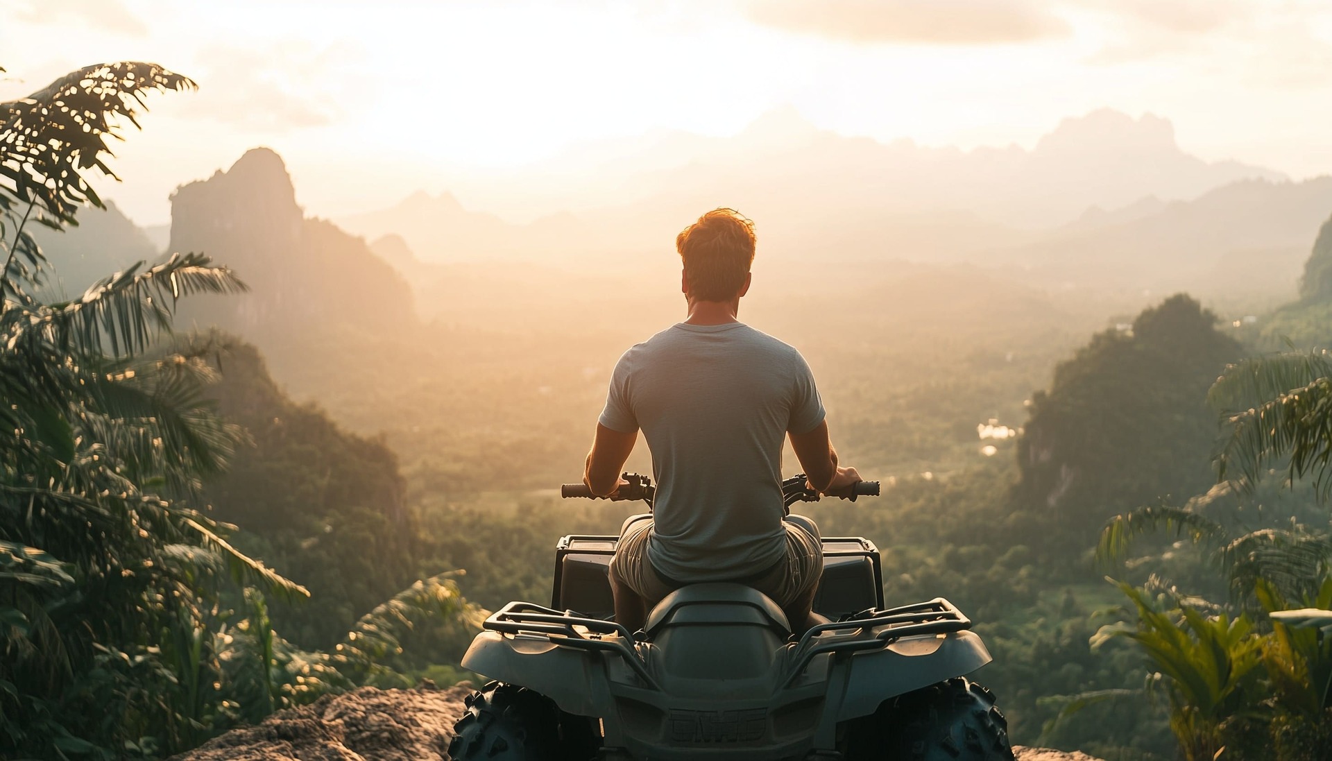 european man riding atv in a thai jungle on top of a cliff.