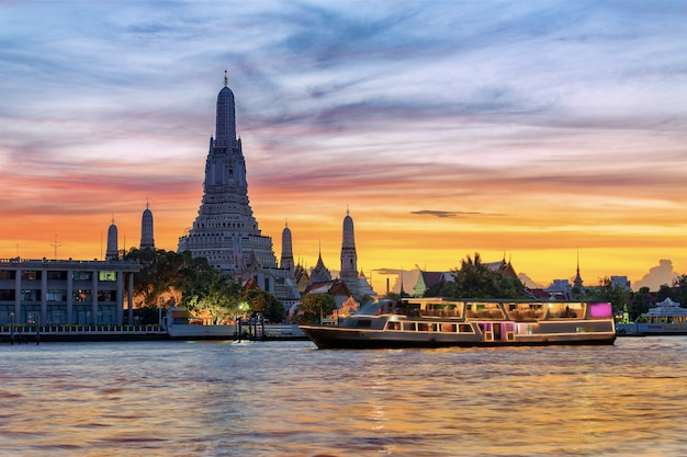 chao-phraya-river-cruise-boat-with-temple-dawn-wat-arun-sunset-background-horizontal_39420-317